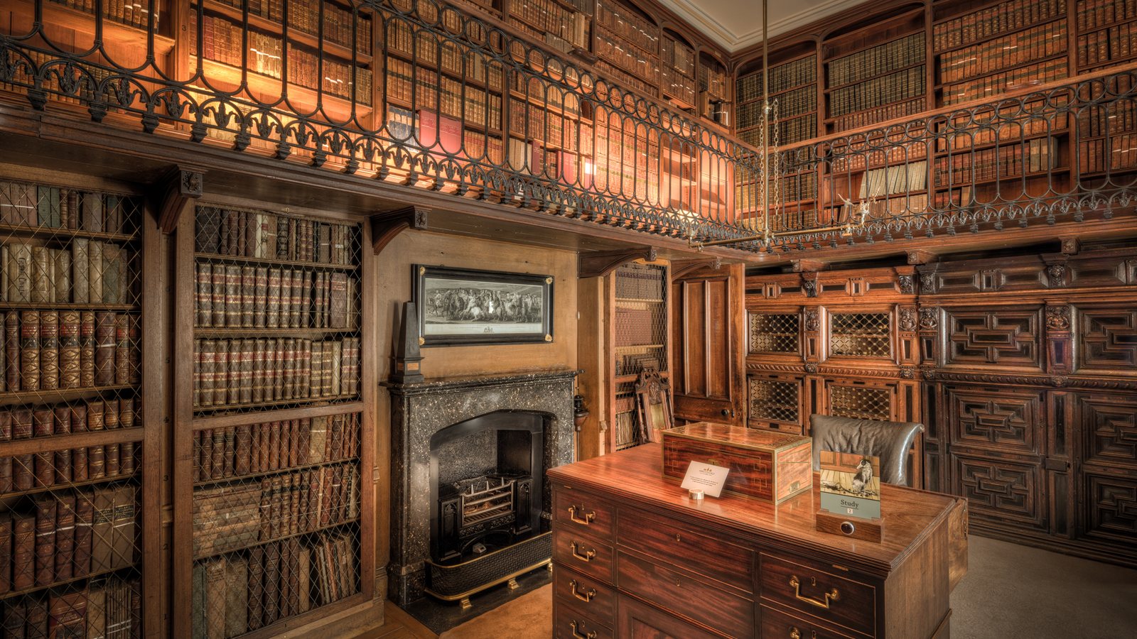 Panelled study room with a desk and bookshelves